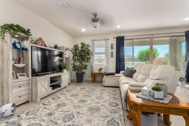 living room with ceiling fan and a healthy amount of sunlight