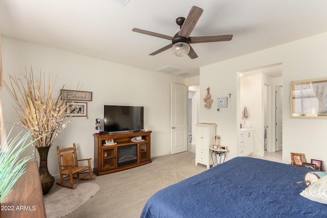 carpeted bedroom featuring ensuite bath and ceiling fan