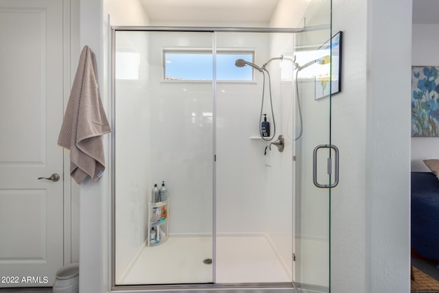 bathroom with a shower with door