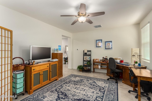 tiled office space with ceiling fan