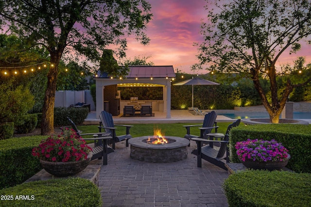 23902 S 202nd Ct, Queen Creek, AZ 85142 - patio terrace at dusk featuring a gazebo, an outdoor fire pit, and fence