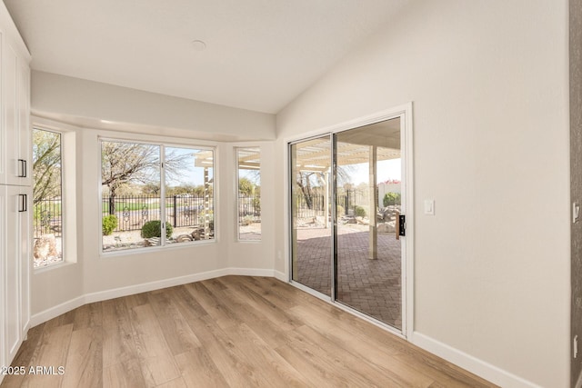 unfurnished sunroom with lofted ceiling