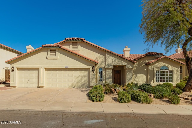 mediterranean / spanish home featuring a garage, driveway, a tile roof, a chimney, and stucco siding