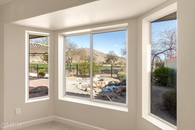 doorway to outside with carpet and baseboards