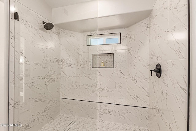 bathroom with a tile shower