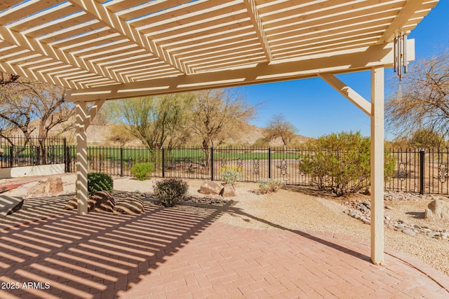 view of patio featuring fence and a pergola