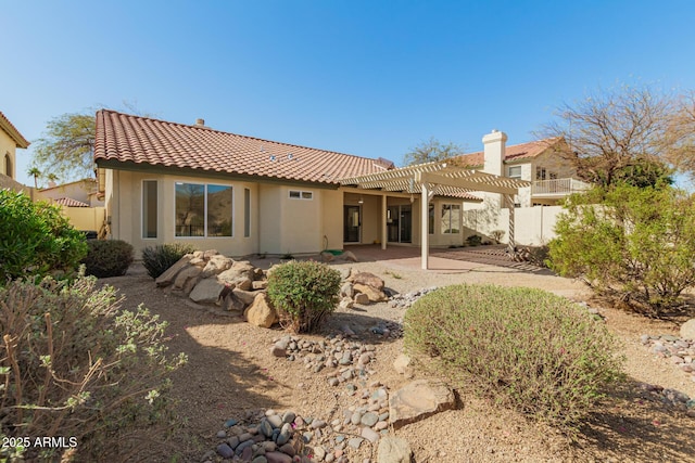 back of house featuring a patio, a tile roof, fence, a pergola, and stucco siding