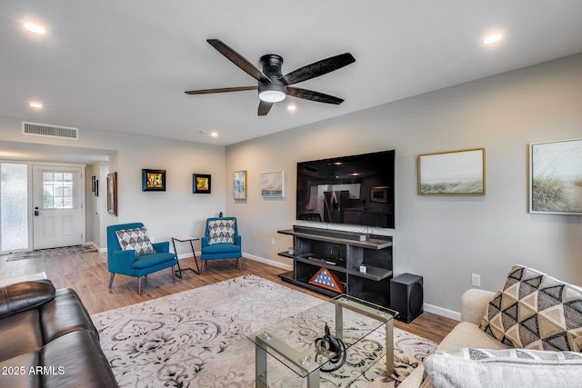 living room featuring hardwood / wood-style flooring and ceiling fan