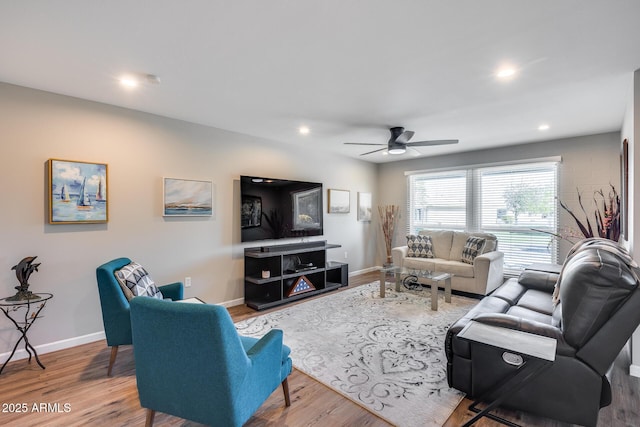 living room with ceiling fan and wood-type flooring