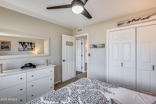 carpeted bedroom featuring a closet and ceiling fan