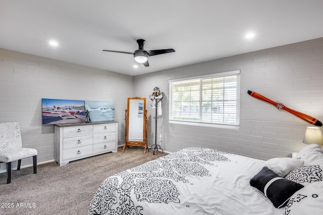 carpeted bedroom featuring brick wall and ceiling fan