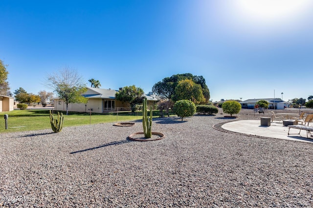 view of property's community with a patio area and a lawn