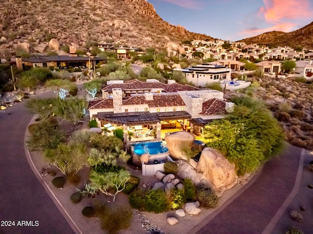 aerial view at dusk featuring a mountain view