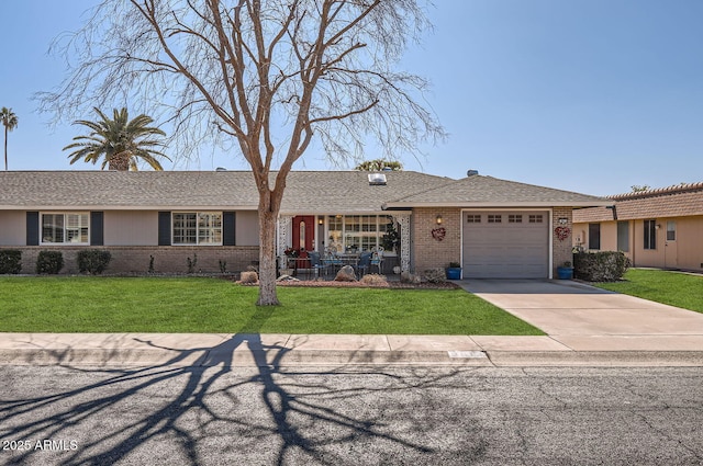 single story home featuring a garage, a porch, and a front yard