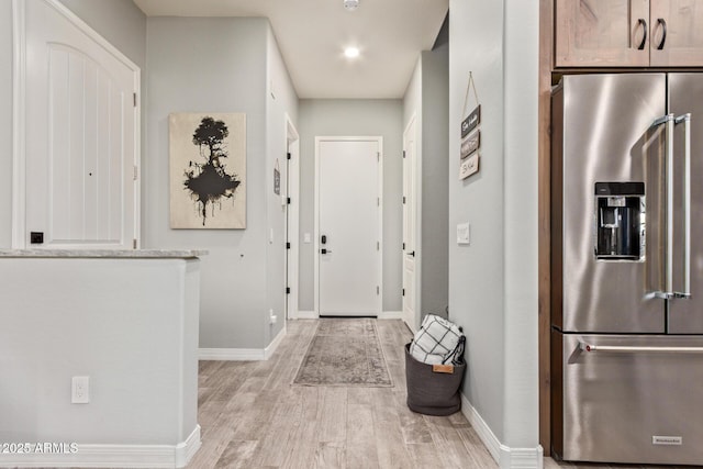 interior space with light wood-style flooring and baseboards