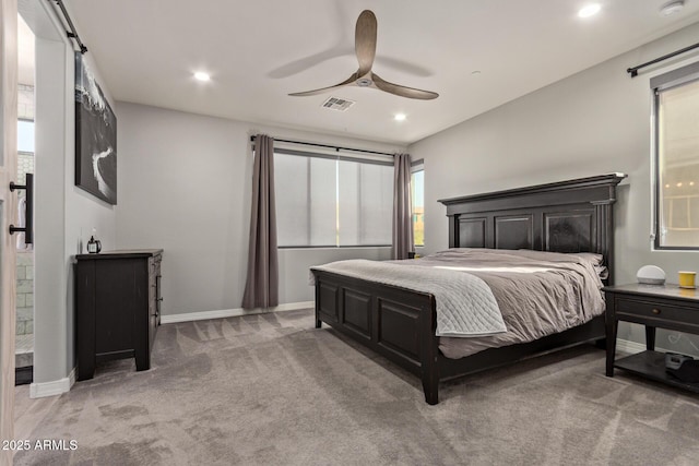 bedroom with a barn door, recessed lighting, light carpet, visible vents, and baseboards