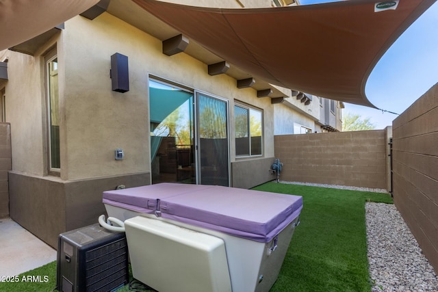 view of patio / terrace featuring a fenced backyard and a hot tub