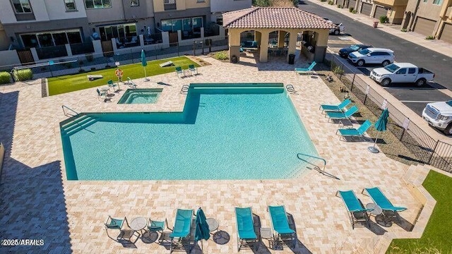 pool with a gazebo, fence, and a patio