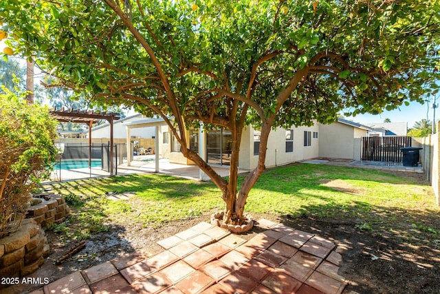 view of yard featuring a fenced in pool, a pergola, and a patio area