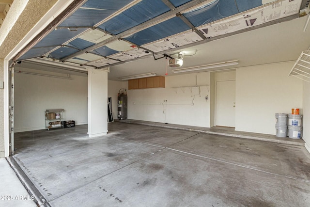 garage with a garage door opener and water heater