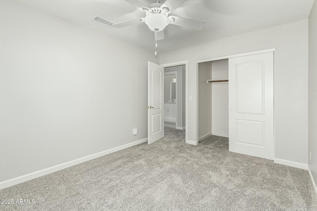 unfurnished bedroom featuring light colored carpet, ceiling fan, and a closet