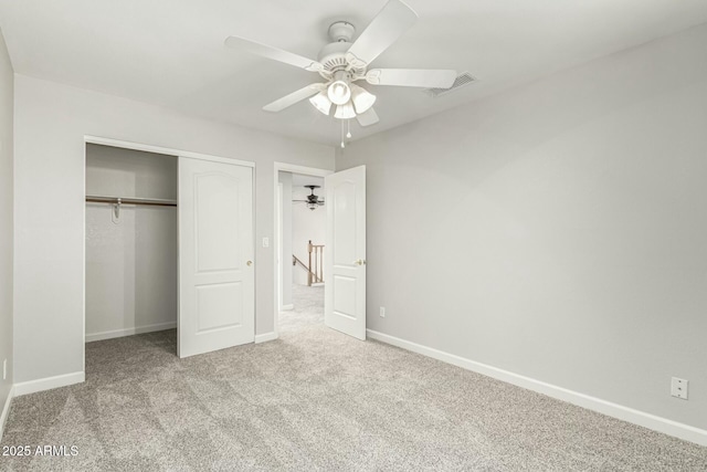 unfurnished bedroom featuring light colored carpet, a closet, and ceiling fan