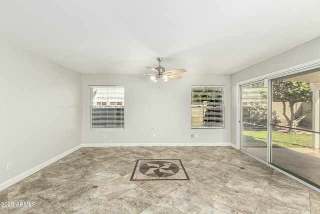 empty room featuring plenty of natural light and ceiling fan