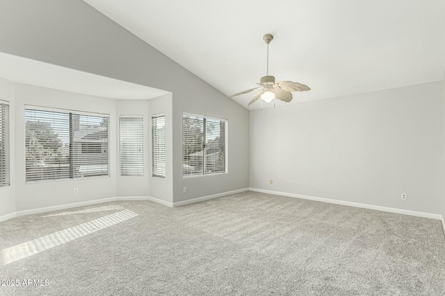 carpeted spare room with ceiling fan and lofted ceiling