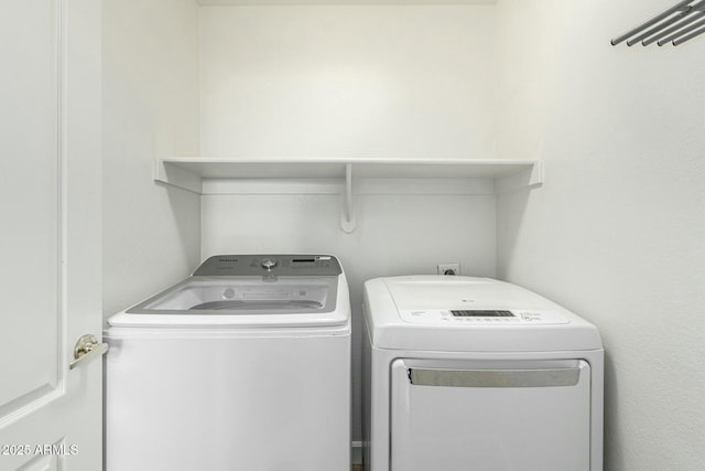 washroom with washing machine and clothes dryer