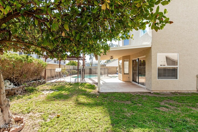 view of yard featuring a fenced in pool and a patio