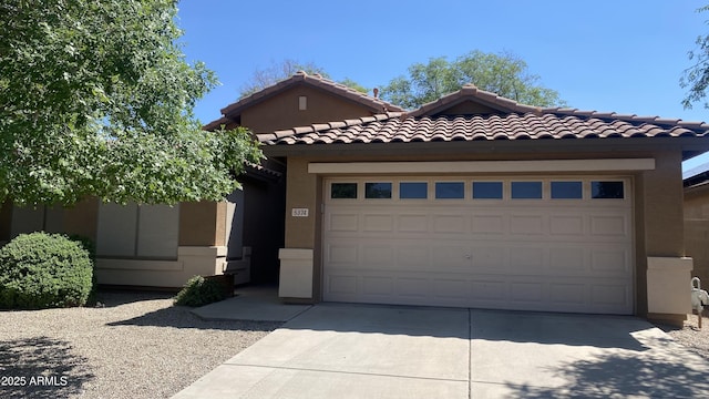 5374 N Ormondo Way, Litchfield Park, AZ 85340 - view of front facade featuring concrete driveway, a garage, stucco siding, and a tiled roof