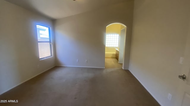 5374 N Ormondo Way, Litchfield Park, AZ 85340 - spare room featuring arched walkways and carpet