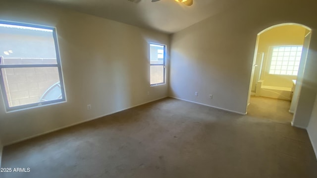 5374 N Ormondo Way, Litchfield Park, AZ 85340 - spare room featuring carpet, arched walkways, and a ceiling fan