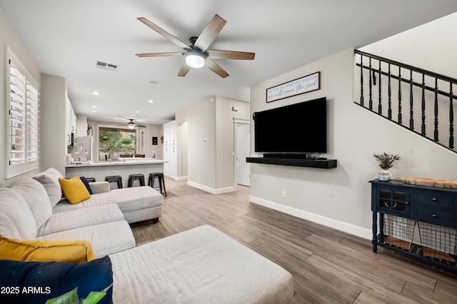 3773 E Stampede Dr, Gilbert, AZ 85297 - living room with a ceiling fan, wood finished floors, baseboards, recessed lighting, and stairs
