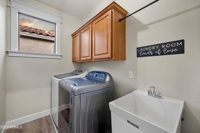 3773 E Stampede Dr, Gilbert, AZ 85297 - laundry area with washer and dryer, wood finished floors, cabinet space, and baseboards