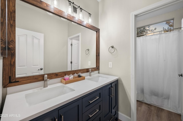 3773 E Stampede Dr, Gilbert, AZ 85297 - bathroom featuring double vanity, wood finished floors, and baseboards