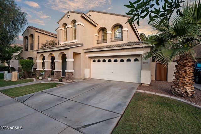 3773 E Stampede Dr, Gilbert, AZ 85297 - mediterranean / spanish-style home with stucco siding, driveway, an attached garage, a tiled roof, and stone siding