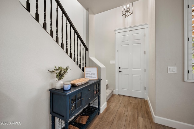 3773 E Stampede Dr, Gilbert, AZ 85297 - foyer entrance featuring stairway, a chandelier, wood finished floors, and baseboards