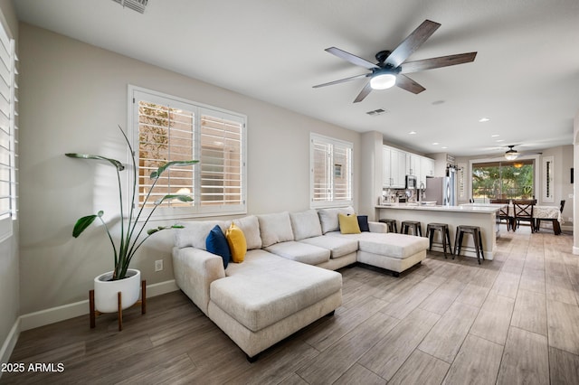 3773 E Stampede Dr, Gilbert, AZ 85297 - living area featuring a ceiling fan, wood finished floors, baseboards, and recessed lighting