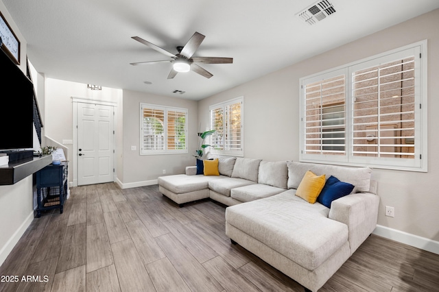 3773 E Stampede Dr, Gilbert, AZ 85297 - living area with ceiling fan, wood finished floors, and baseboards
