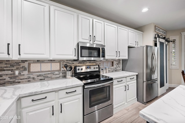 3773 E Stampede Dr, Gilbert, AZ 85297 - kitchen with stainless steel appliances, white cabinetry, decorative backsplash, light stone countertops, and recessed lighting