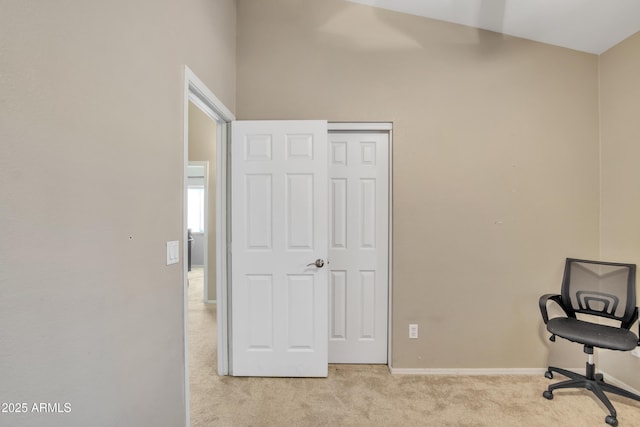 carpeted home office with baseboards