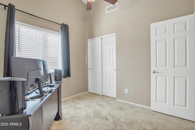 carpeted home office featuring ceiling fan, visible vents, and baseboards