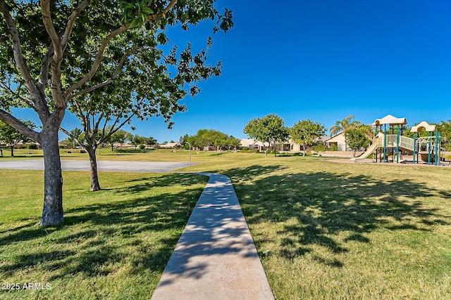 view of home's community with playground community and a yard