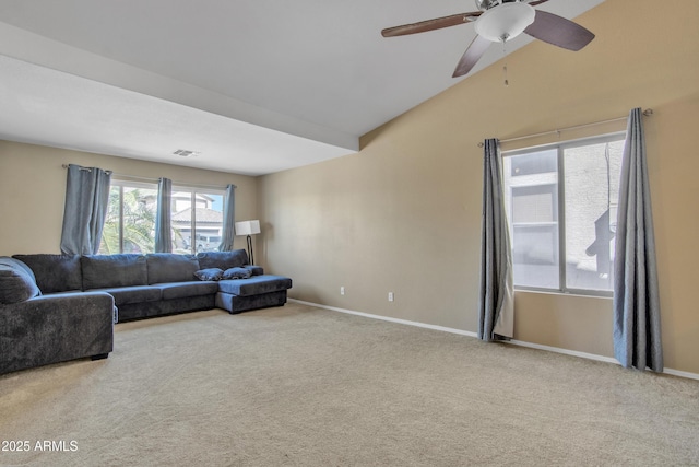 carpeted living area with a ceiling fan, visible vents, vaulted ceiling, and baseboards