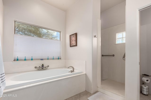 bathroom featuring shower with separate bathtub and tile patterned flooring