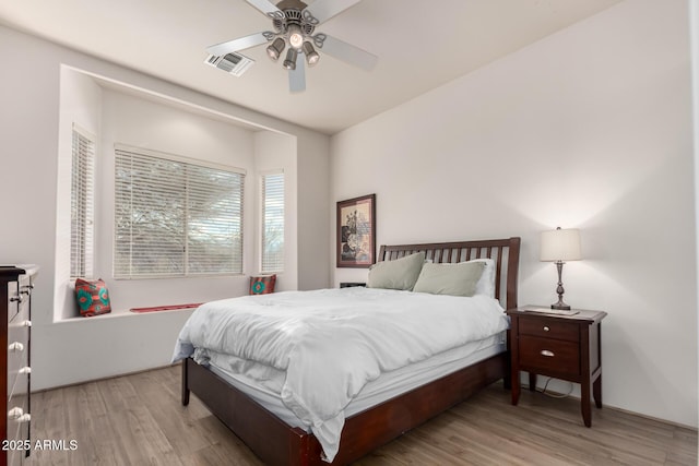 bedroom with ceiling fan and light wood-type flooring