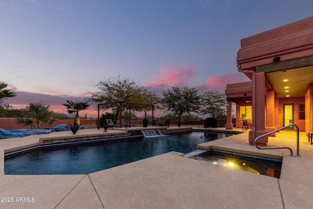 pool at dusk with an in ground hot tub, ceiling fan, and a patio