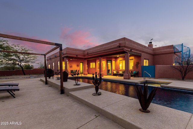 exterior space featuring a fenced in pool and a patio