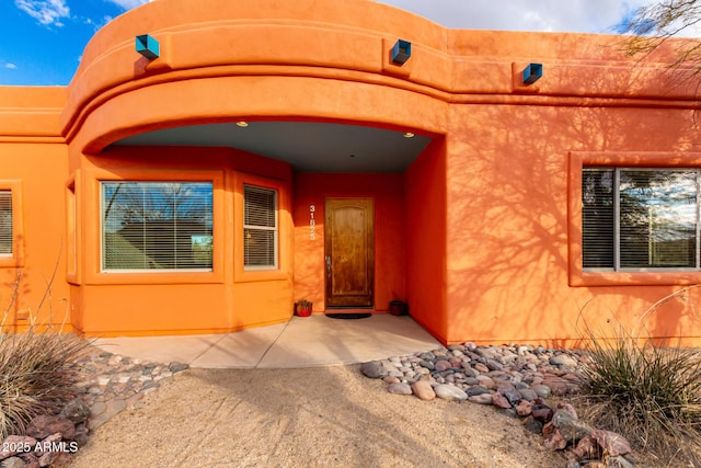 entrance to property with a patio